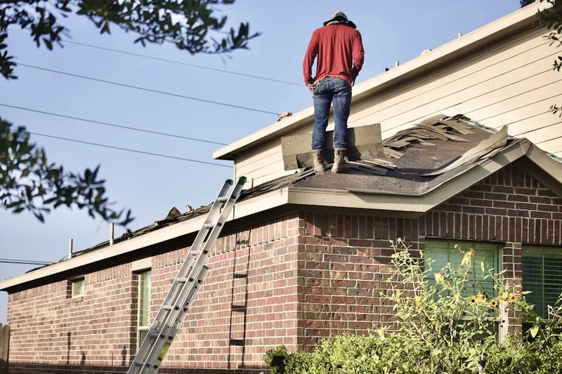 Professional roofer working on a residential roof in Old Tallapoosa